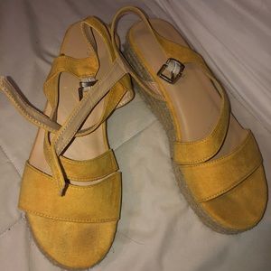 Yellow suede espadrille wedge sandals.